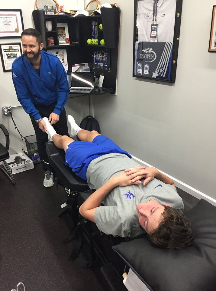 Physical therapist foot assessment with athlete